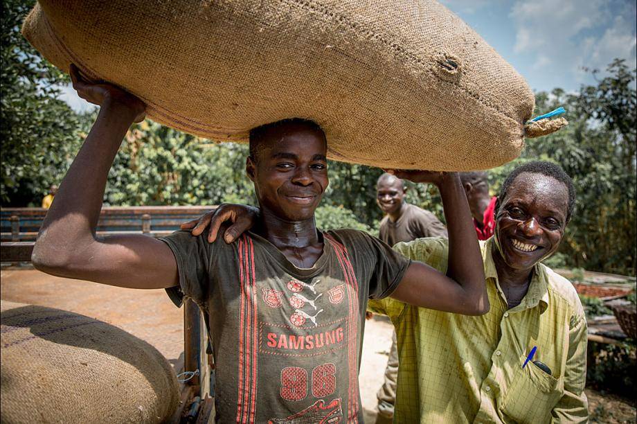 Cocoa farmers with bag of cocoa beans