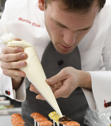 chef martin piping chocolate onto application