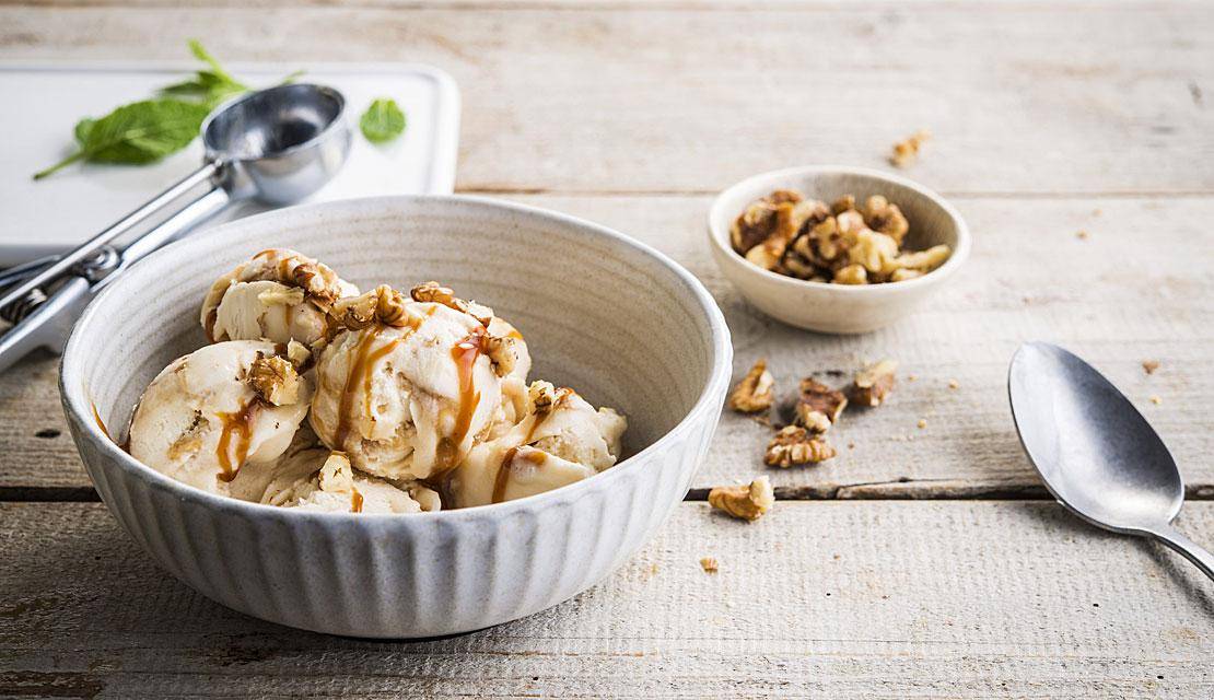 Homemade caramel ice cream with rippled caramel and caramelized nuts